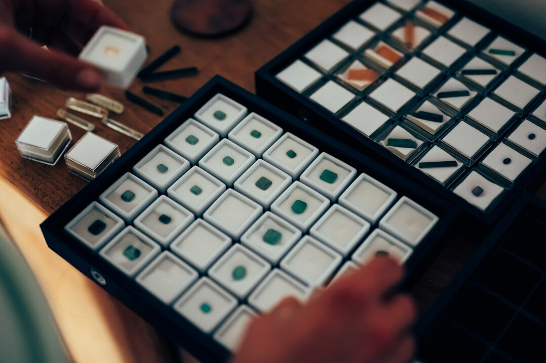 Close-up of hands analyzing market saturation graphs on paper
